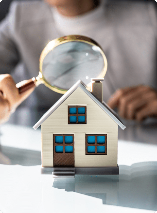 Home inspection with a magnifying glass and model house