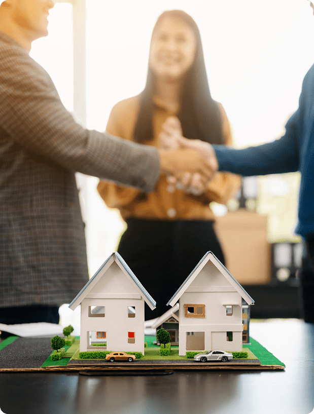 Home buyers discussing a property sale with model houses
