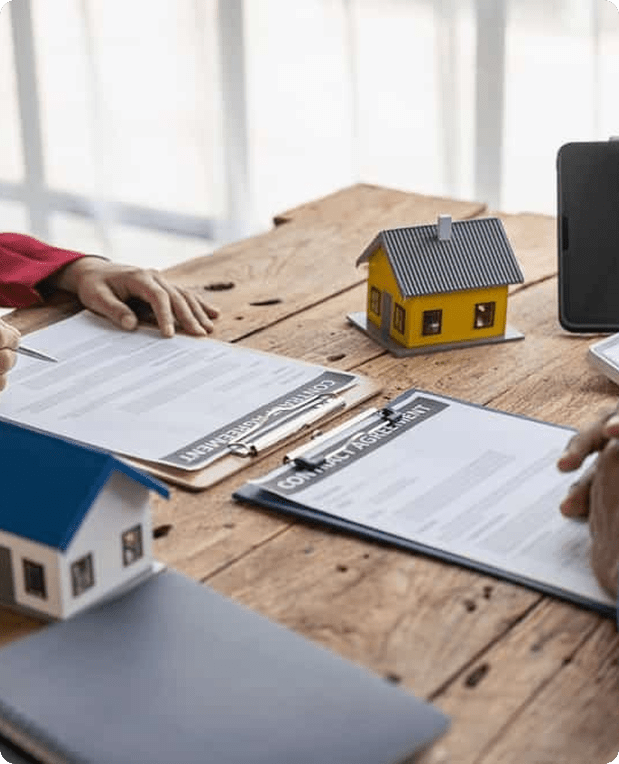 House model with property documents and blueprints